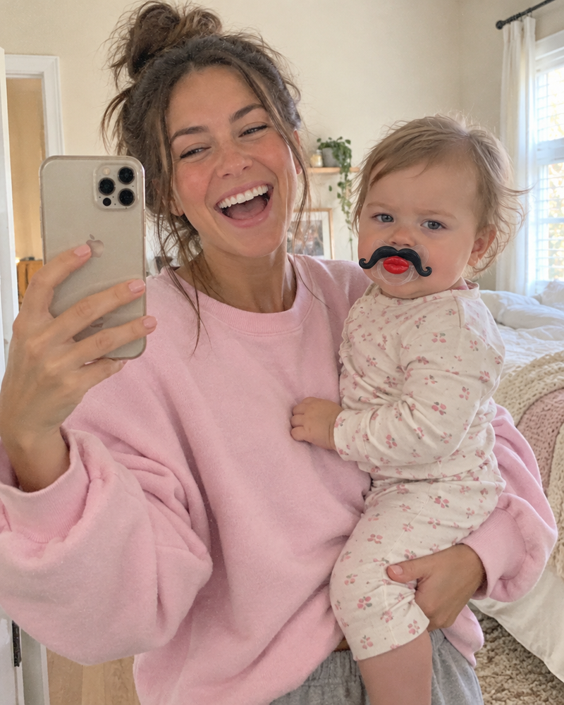 Mom laughing with baby wearing Mini Mister